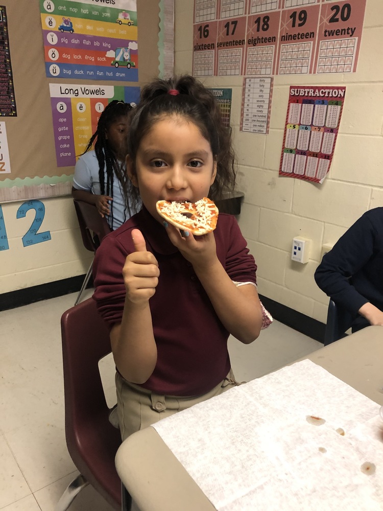 Second grader enjoying pizza
