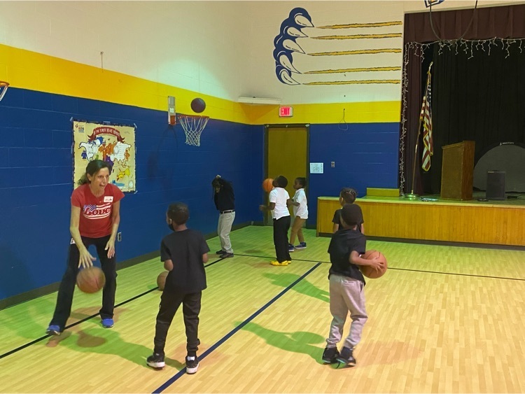 adult and two students playing basketball 