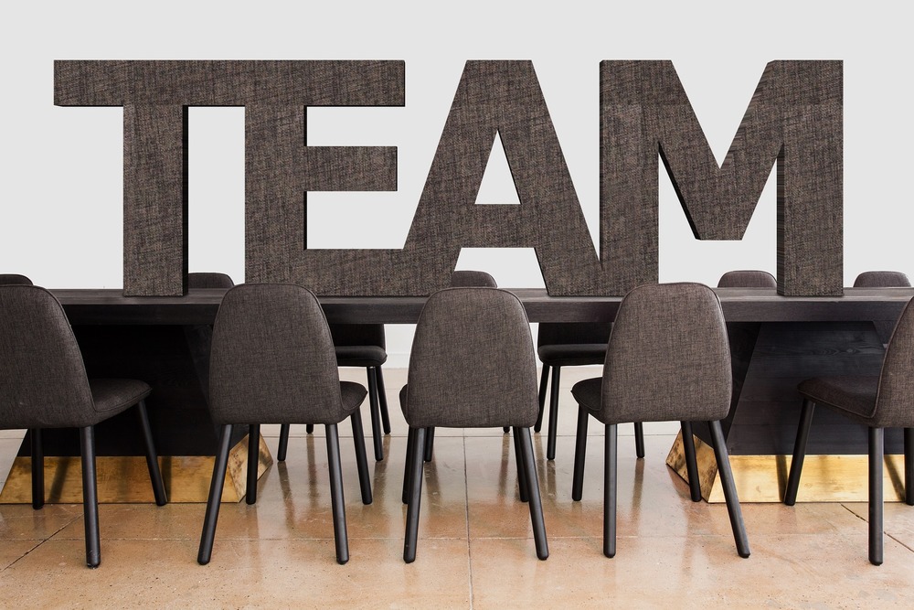 Desk and chairs with Team spelled out on top of the table