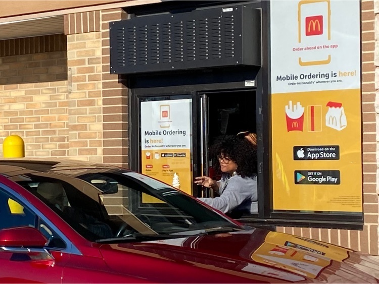 woman leaning out drive thru window
