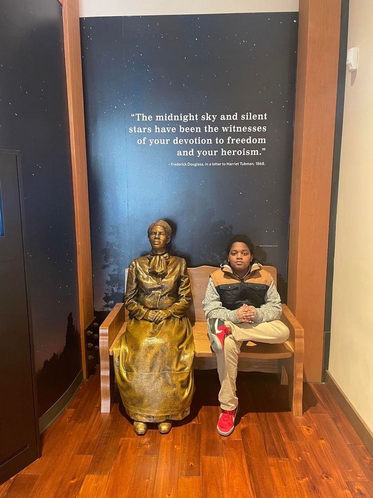 student next to Harriet Tubman statue 