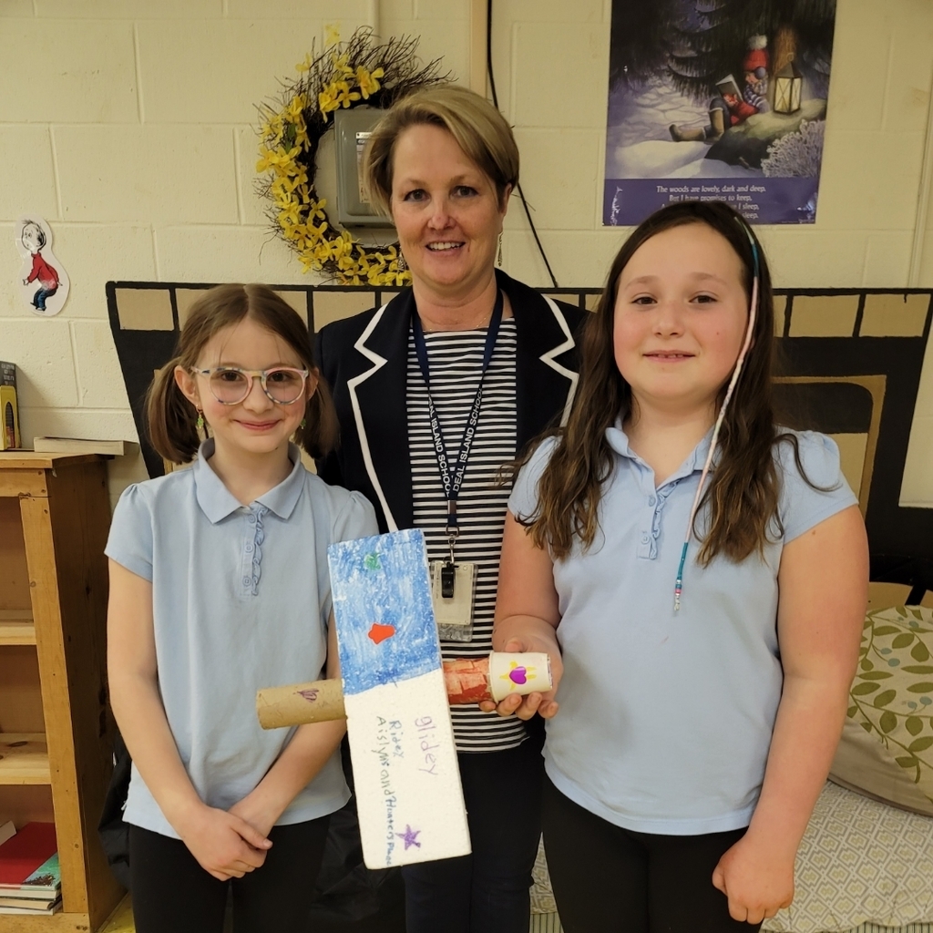 Mrs. Kelly with her two students and their winning airplane.